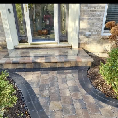 Tumbled-paver front steps leading to a curved walkway.